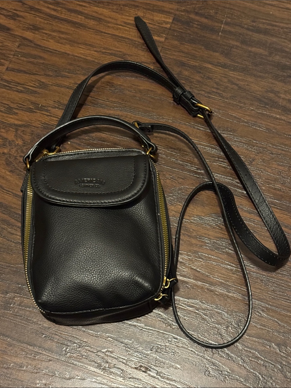 Compact Black Pebbled Leather Crossbody Bag with Gold Hardware